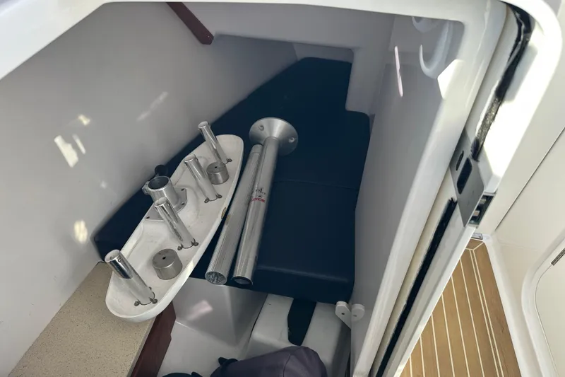 Slide: The Image of Interior of a 2020 Southport 33DC boat showing storage area with metal fixtures. - 31