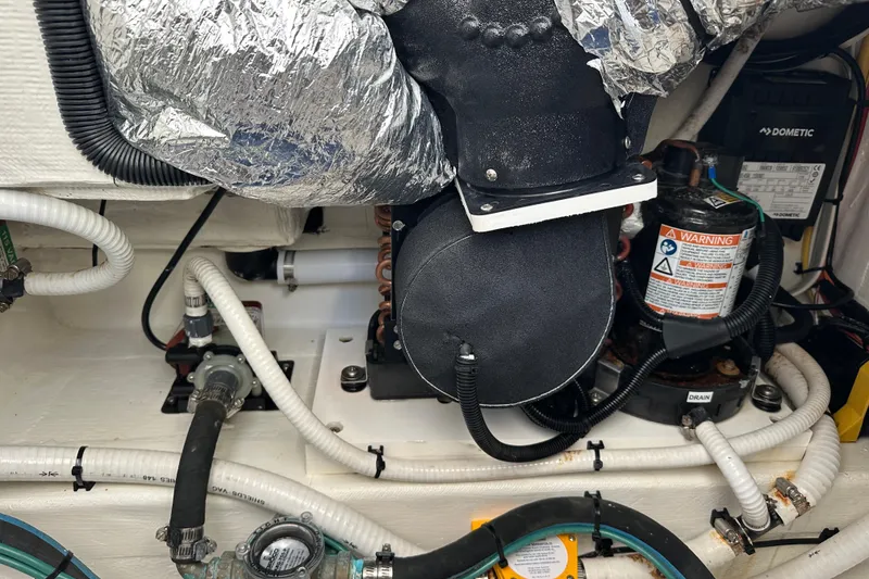 Slide: The Image of Engine compartment of a 2020 Southport 33DC boat with various mechanical components. - 32