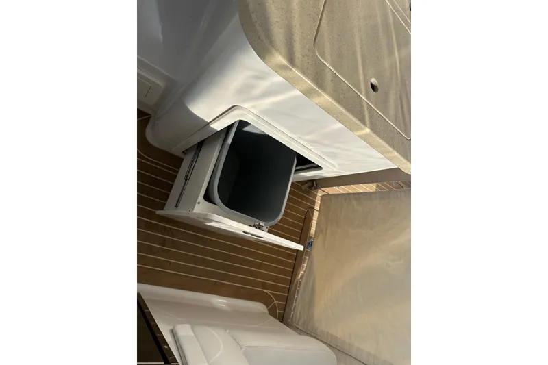 Slide: The Image of Interior of 2020 Southport 33DC boat showing open storage compartment and countertop. - 34