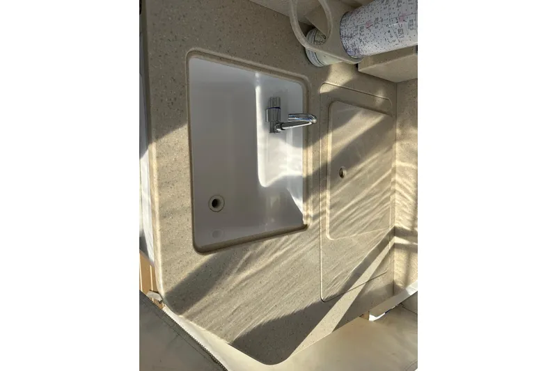 Slide: The Image of 2020 Southport 33DC boat sink and countertop with faucet in sunlight. - 36
