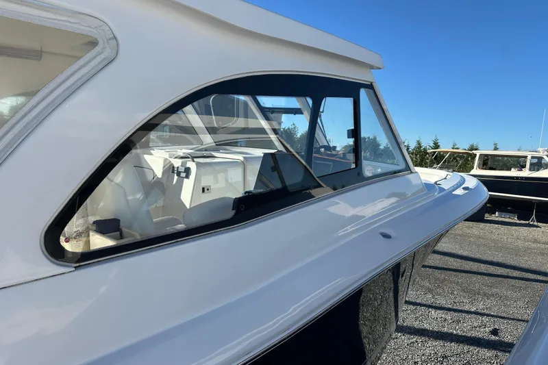 Slide: The Image of 2020 Southport 33DC boat side view with sleek design and clear windows. - 7