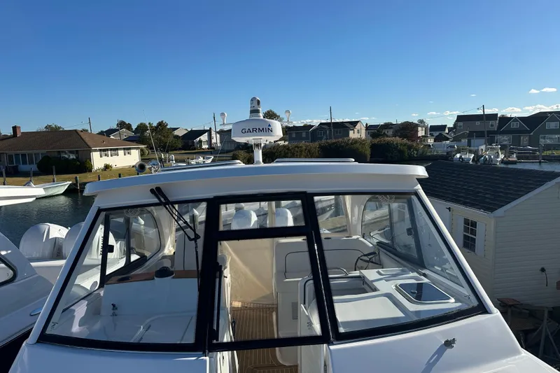 Slide: The Image of 2020 Southport 33DC boat with Garmin equipment, docked in a residential marina. - 8
