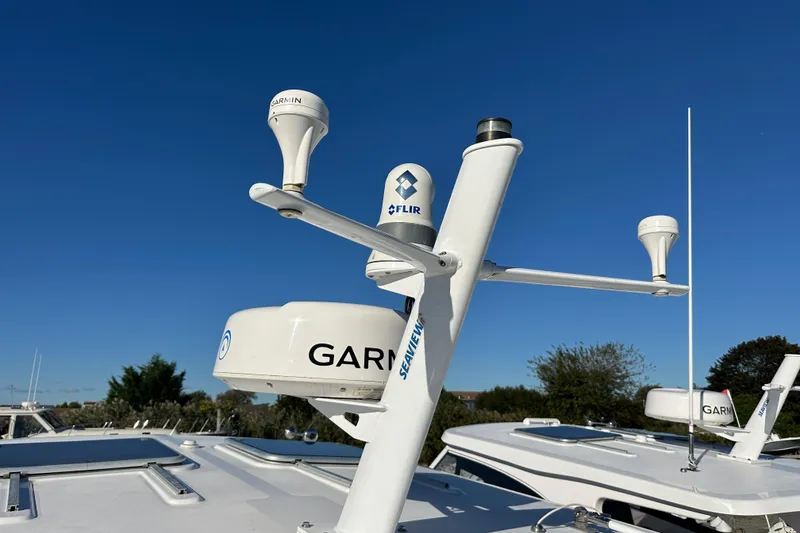 Slide: The Image of Radar and communication equipment on a 2020 Southport 33DC boat under clear blue sky. - 9