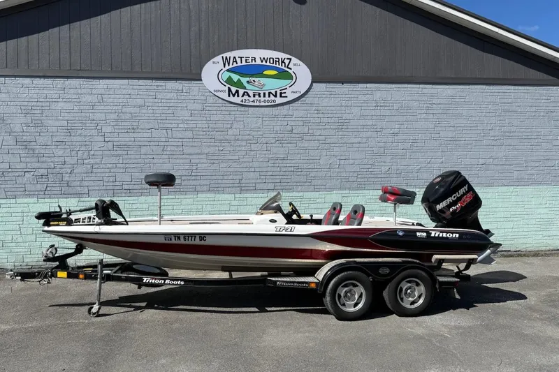 Slide: The Image of 2000 Triton TR21DC boat with Mercury Pro XS engine, parked at Water Workz Marine. - 1