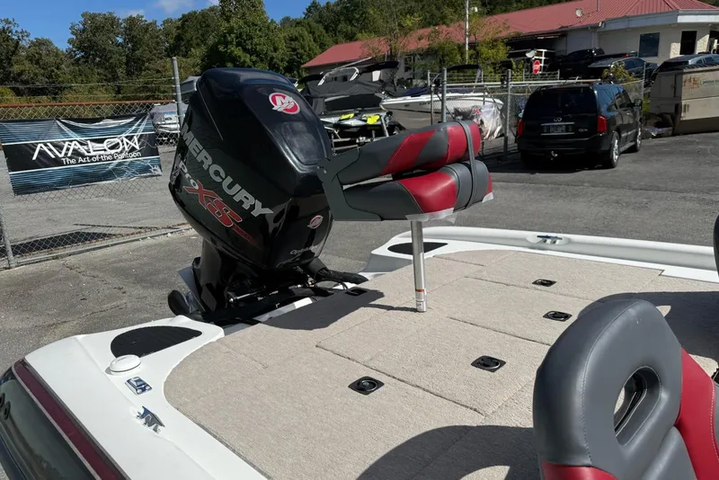 Slide: The Image of 2000 Triton TR21DC boat with Mercury Pro XS engine in a parking lot. - 6