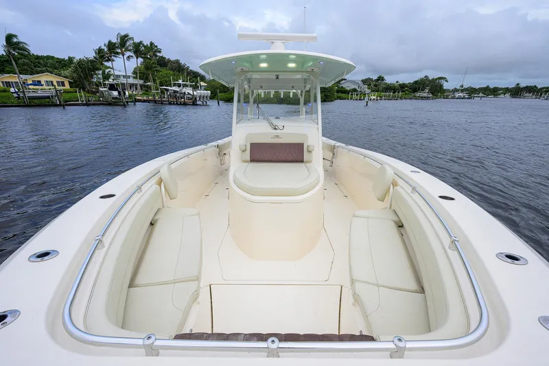 Slide: The Image of 2020 Cobia 350 CC boat with spacious seating on calm waters. - 15