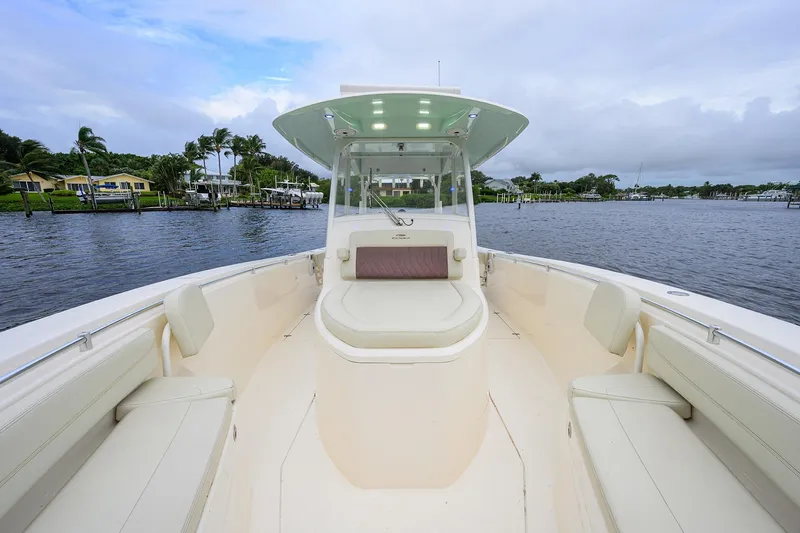 Slide: The Image of 2020 Cobia 350 CC boat on calm water, featuring spacious seating and modern design. - 16