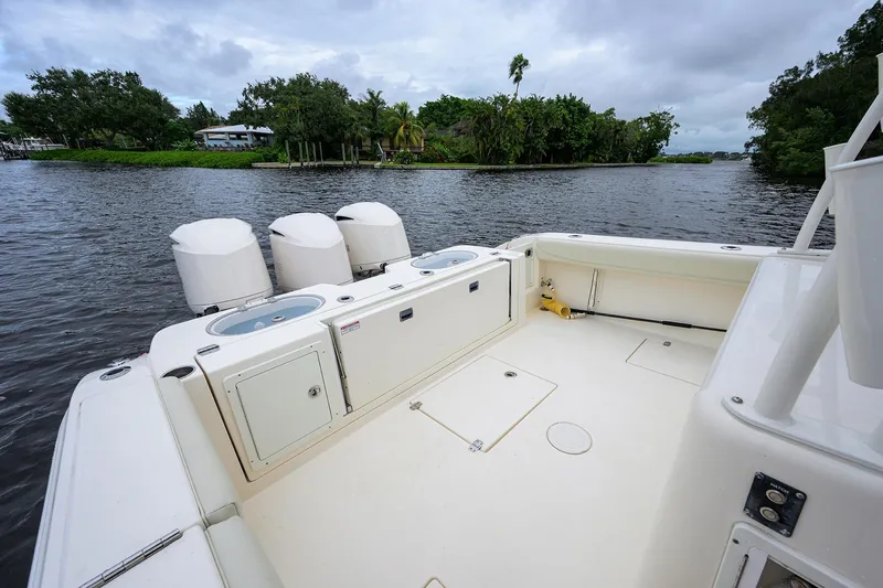 Slide: The Image of 2020 Cobia 350 CC boat with triple engines on a calm river. - 26