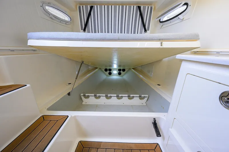 Slide: The Image of 2020 Cobia 350 CC cabin interior with storage and seating area. - 40