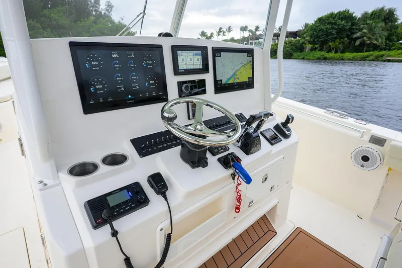 Slide: The Image of 2020 Cobia 350 CC boat dashboard with advanced navigation and control systems. - 42