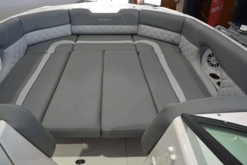 Slide: The Image of 2026 NauticStar 243 DC Deck boat interior with gray cushioned seating. - 14