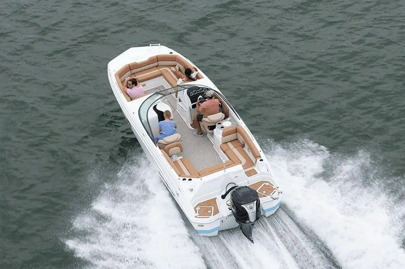 Slide: The Image of 2026 NauticStar 243 DC Deck boat displayed indoors at a boat show. - 3