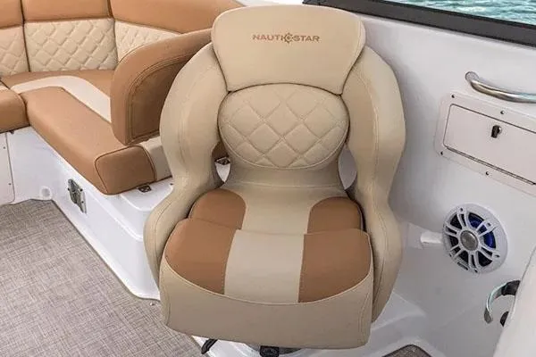 Slide: The Image of 2026 NauticStar 243 DC Deck boat displayed indoors with Yamaha outboard motor. - 6