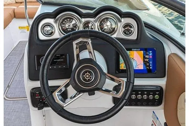 Slide: The Image of 2026 NauticStar 243 DC Deck boat interior with plush seating and table. - 7