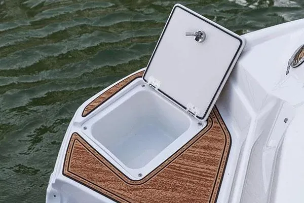 Slide: The Image of 2026 NauticStar 243 DC Deck boat interior with canopy, showcased indoors. - 9