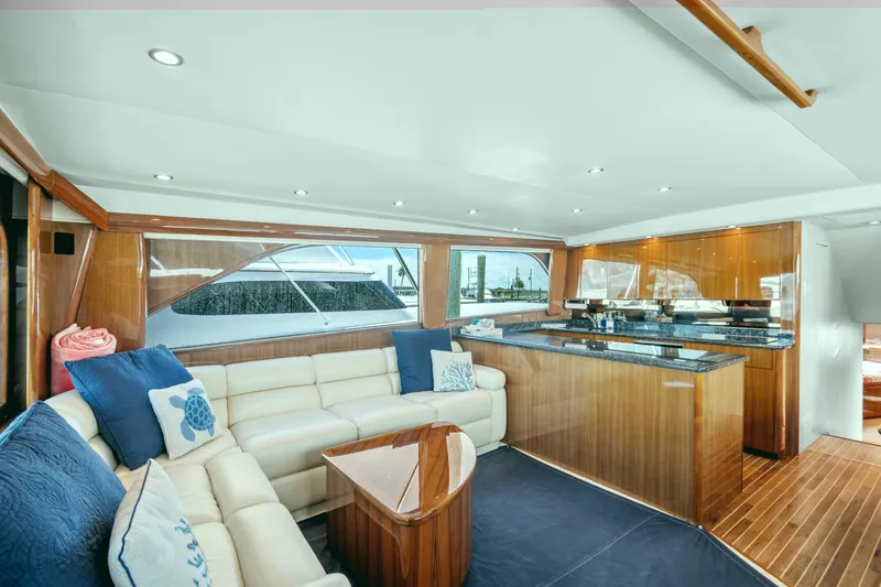 Slide: The Image of Luxurious interior of a 2005 Viking 61 Convertible yacht with elegant wood finishes. - 14