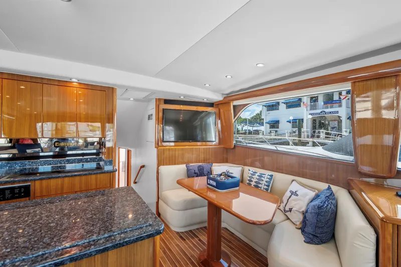 Slide: The Image of Luxurious interior of 2005 Viking 61 Convertible yacht with elegant seating and modern amenities. - 16