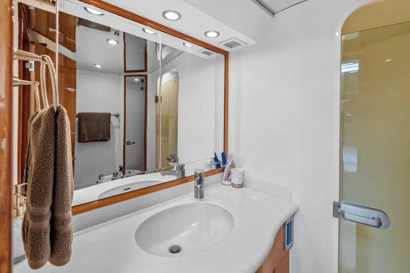 Slide: The Image of Luxurious bathroom in 2005 Viking 61 Convertible yacht with modern fixtures and elegant design. - 21