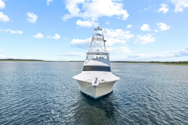 Slide: The Image of 2005 Viking 61 Convertible yacht on open water under blue sky. - 3
