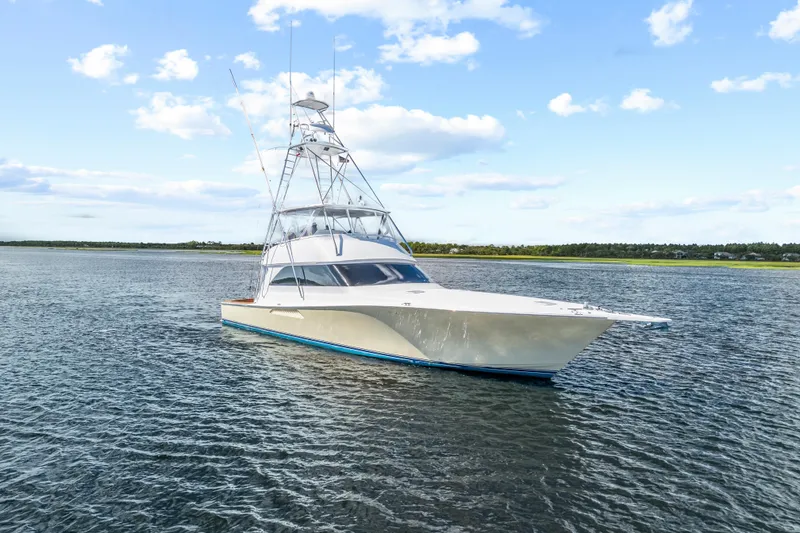 Slide: The Image of 2005 Viking 61 Convertible yacht on calm water under a blue sky. - 5