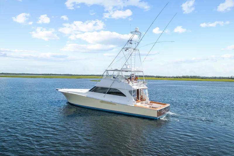 Slide: The Image of 2005 Viking 61 Convertible yacht cruising on calm waters under a clear sky. - 7