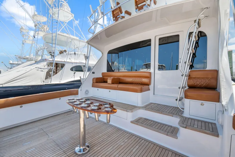 Slide: The Image of 2005 Viking 61 Convertible yacht deck with seating and fishing rod holders. - 9