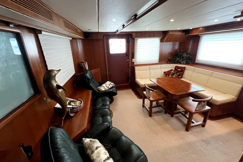 Slide: The Image of Luxurious 2011 Nordhavn 60 yacht interior with elegant seating and wooden dining area. - 11