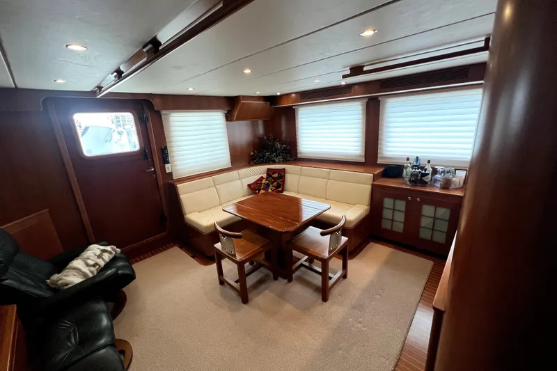Slide: The Image of Luxurious 2011 Nordhavn 60 yacht interior with elegant dining area and plush seating. - 13