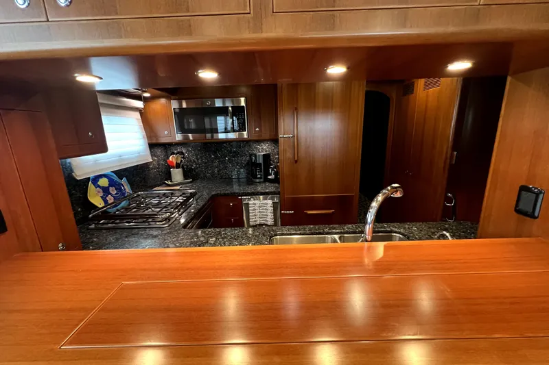 Slide: The Image of Luxurious kitchen interior of 2011 Nordhavn 60 yacht with wood cabinetry and modern appliances. - 14