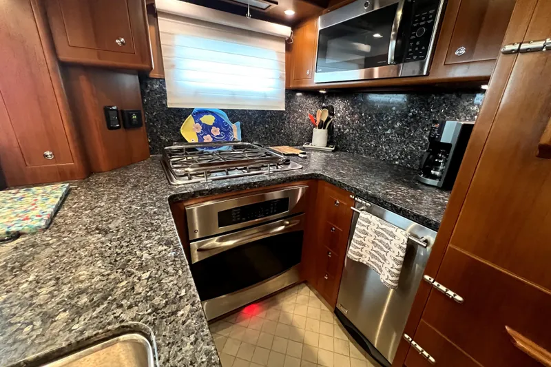 Slide: The Image of Luxurious 2011 Nordhavn 60 yacht kitchen with granite countertops and modern appliances. - 15