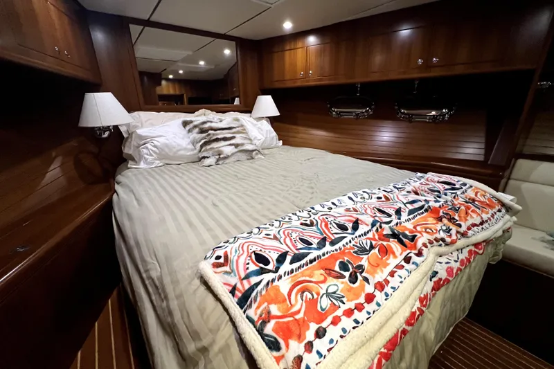 Slide: The Image of Luxurious 2011 Nordhavn 60 yacht bedroom with cozy bedding and elegant wood paneling. - 21