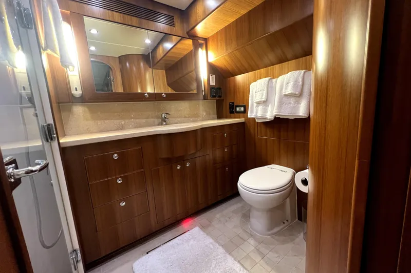 Slide: The Image of Luxurious bathroom in 2011 Nordhavn 60 yacht with wood cabinetry and modern fixtures. - 22