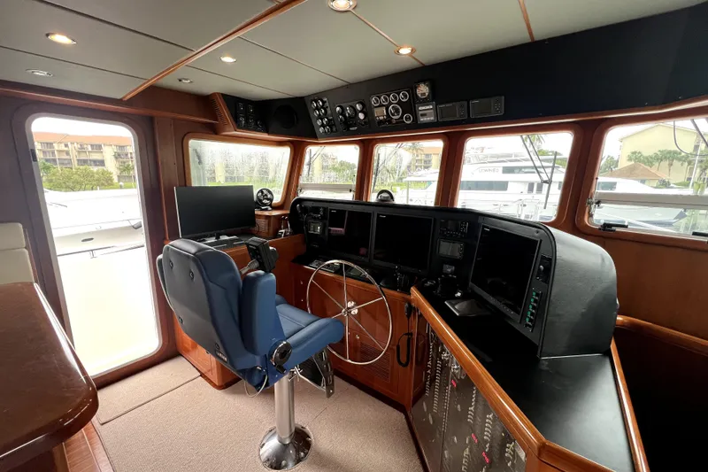 Slide: The Image of Pilothouse of 2011 Nordhavn 60 yacht with navigation equipment and captain's chair. - 24