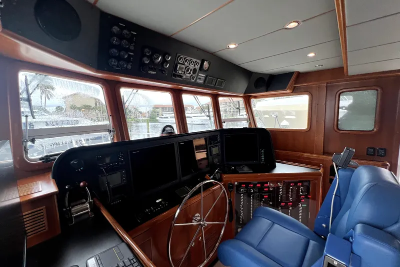Slide: The Image of Pilothouse of 2011 Nordhavn 60 yacht with navigation equipment and blue captain's chair. - 25