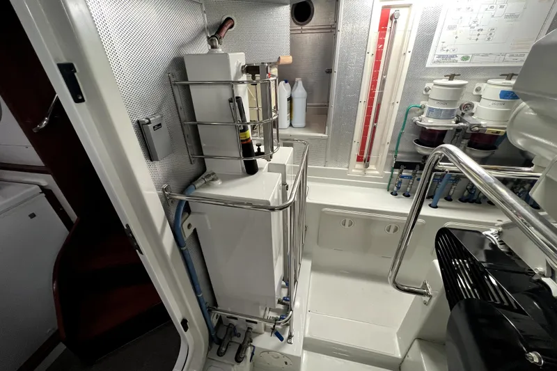 Slide: The Image of Engine room of a 2011 Nordhavn 60 yacht, featuring equipment and control panels. - 33
