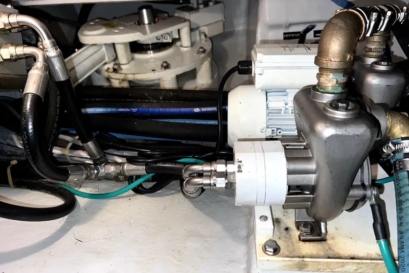 Slide: The Image of Engine room of a 2011 Nordhavn 60 yacht, showcasing mechanical components and piping. - 34