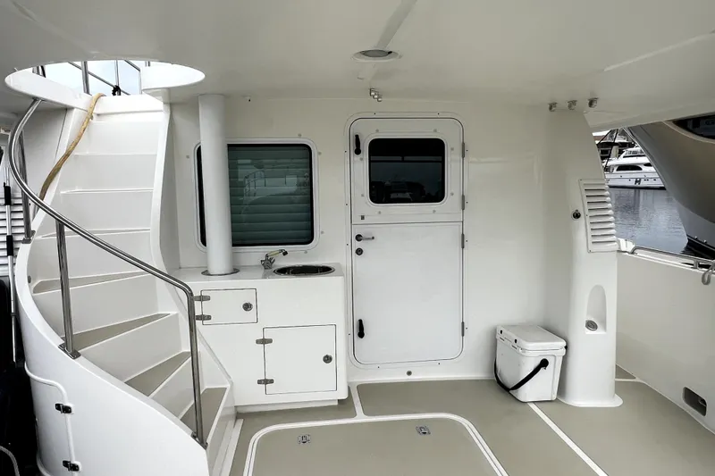 Slide: The Image of Nordhavn 60 yacht deck, 2011 model, featuring stairs, door, and compact sink area. - 4