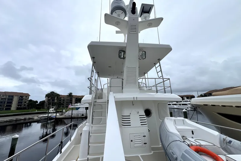 Slide: The Image of Nordhavn 60 yacht, 2011 model, docked with visible upper deck and lifeboat. - 5