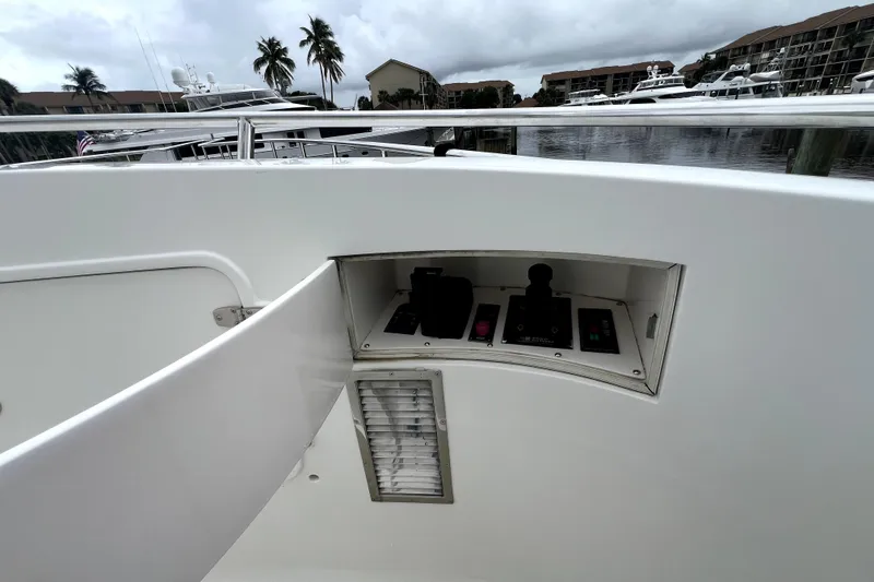 Slide: The Image of Control panel on a 2011 Nordhavn 60 yacht, docked with palm trees in the background. - 9