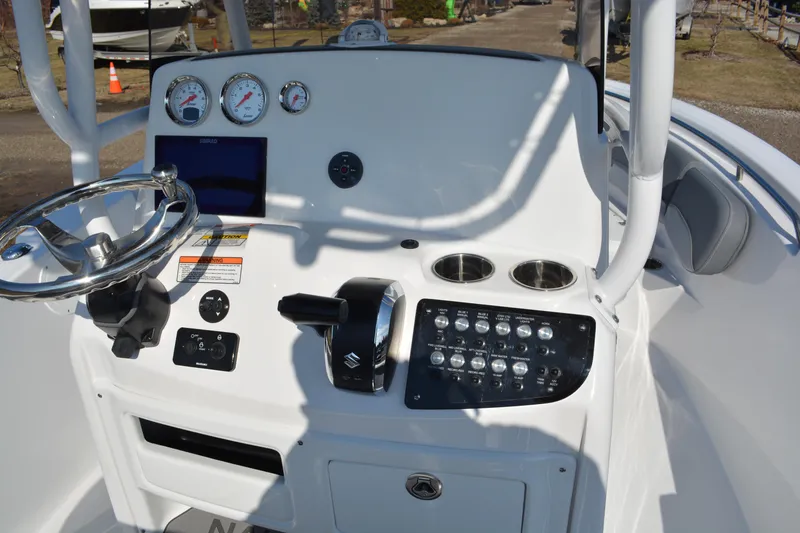 Slide: The Image of 2026 NauticStar 212 Legacy boat dashboard with steering wheel and control panel. - 12