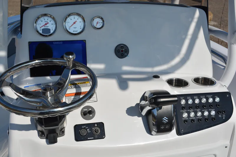 Slide: The Image of 2026 NauticStar 212 Legacy boat dashboard with steering wheel, gauges, and control panel. - 13
