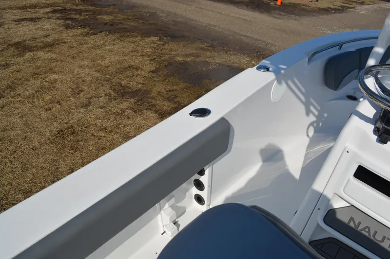 Slide: The Image of 2026 NauticStar 212 Legacy boat interior with steering wheel and seating. - 16