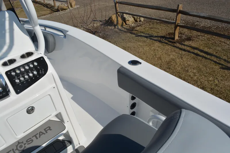 Slide: The Image of 2026 NauticStar 212 Legacy boat interior with control panel and seating. - 17