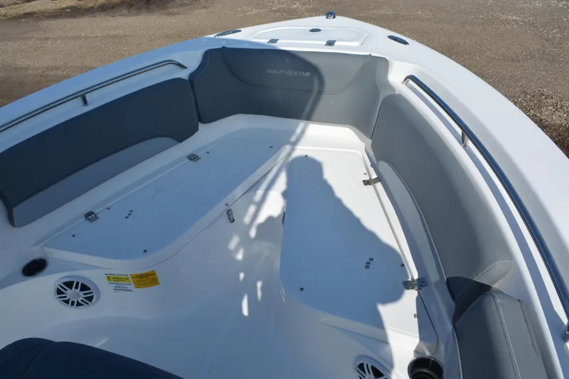 Slide: The Image of 2026 NauticStar 212 Legacy boat interior with cushioned seating and storage compartments. - 21