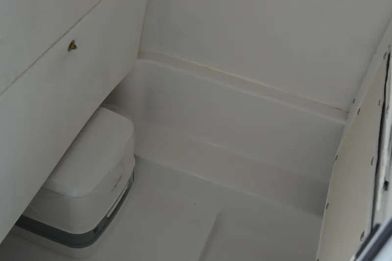 Slide: The Image of Interior of 2026 NauticStar 212 Legacy boat, featuring compact storage space. - 25