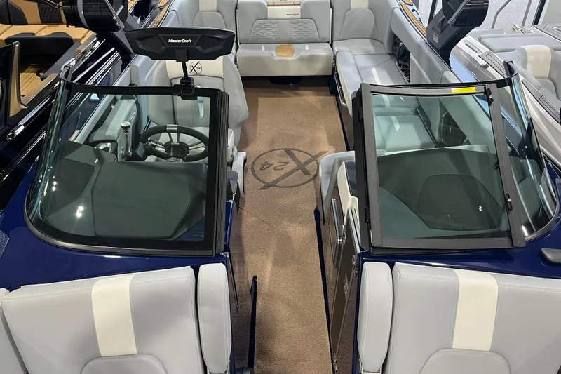 Slide: The Image of 2025 MasterCraft X24 boat interior with sleek seating and modern dashboard design. - 10