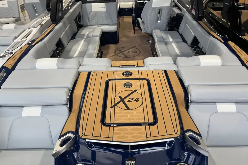 Slide: The Image of 2025 MasterCraft X24 boat interior with luxurious seating and stylish design. - 6