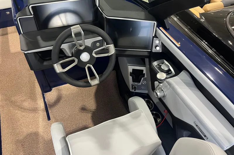 Slide: The Image of 2025 MasterCraft X24 boat cockpit with modern steering wheel and digital controls. - 7
