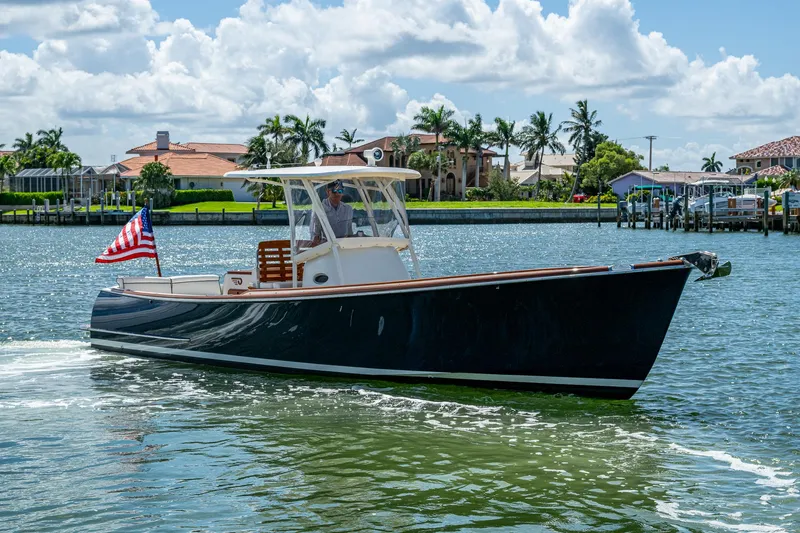 Slide: The Image of 2003 Hinckley Talaria 29 Center Console boat cruising on a sunny day. - 15