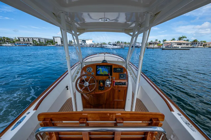 Slide: The Image of 2003 Hinckley Talaria 29 Center Console on water, showcasing helm and navigation equipment. - 7